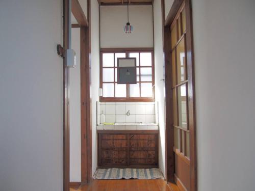 a hallway with a window and a door with a tv at Higashiyama no Kobesso - Vacation STAY 14451 in Kitakyushu