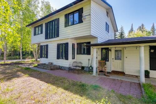 a white house with a patio in front of it at 3 Mi to Pioneer Park and University Spacious Home! in Fairbanks