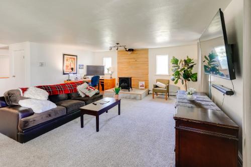 a living room with a couch and a table at 3 Mi to Pioneer Park and University Spacious Home! in Fairbanks