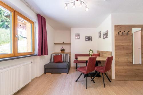 a dining room with a table and a chair at MOUNTAIN RESIDENCE ALPENHOF - company Hotel Alpenhof KG sas der Gasser Renate in Bressanone