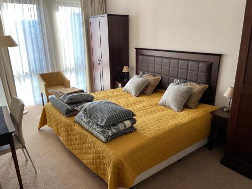 a bedroom with a bed with blankets and pillows on it at ROYAL BEACH & APARTAMENT in Sunny Beach