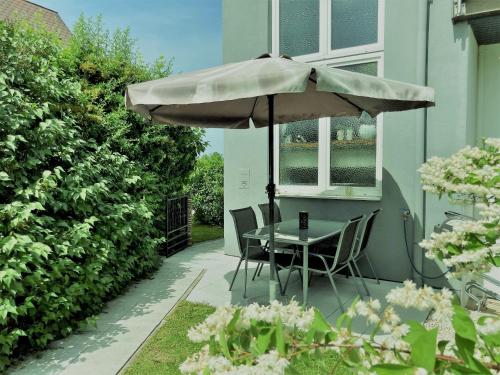 a table and chairs under an umbrella on a patio at Apartment Sonne in Waidhofen an der Thaya