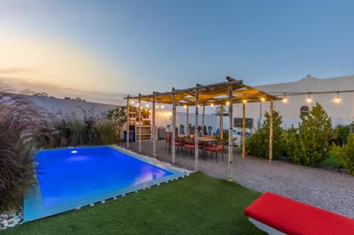 a backyard with a swimming pool and a pergola at My Way in Ras al Khaimah