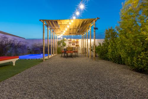 a patio with a table and chairs under a pergola at My Way in Ras al Khaimah