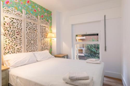 a bedroom with a white bed and a window at H-A Aparthotel Hotel Quo in Madrid