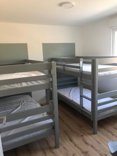 a room with three bunk beds in it at Bruit de mer in Saint-Jean-de-Monts