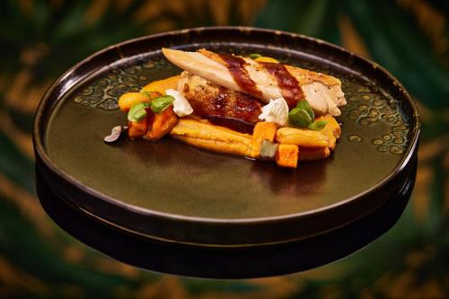 a plate of food with a sandwich and french fries at Mystery Hotel Budapest, Preferred Hotels & Resorts in Budapest