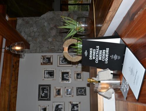 a room with a wall with pictures on it at Barefoot Addo Elephant Lodge in Addo