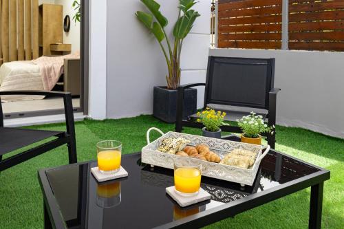 a tray of food on a table with orange juice at Casa Dionysia - New Lux 2Br with Jacuzzi near Maleme Beach in Maleme