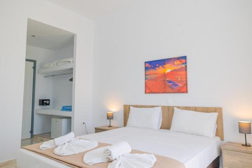 1 dormitorio con 1 cama blanca grande y toallas. en Viva Tourismo Resort (naturist club) en Paradeísion