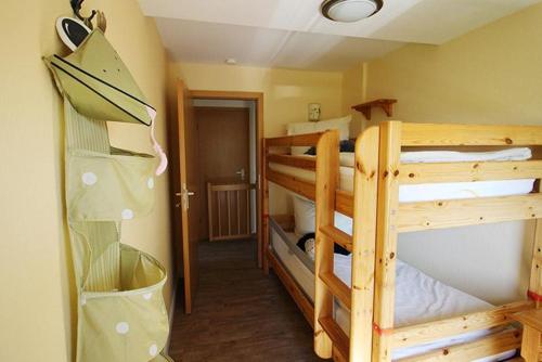 a room with two bunk beds and a hallway at Muschel in Bliesdorf