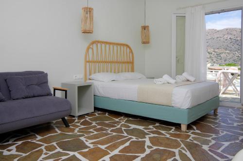 a bedroom with a bed and a chair and a window at Remvi in Galissas