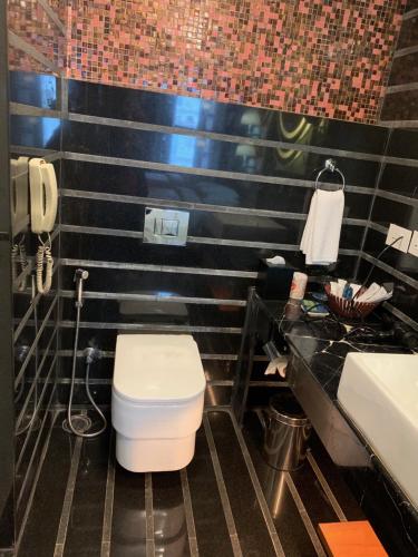 a bathroom with a toilet and a sink at Four Points By Sheraton Visakhapatnam in Visakhapatnam