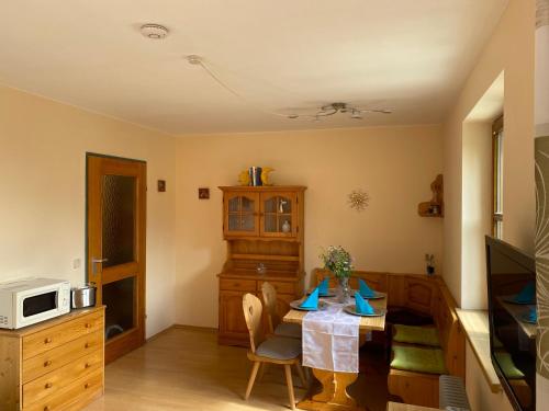 a dining room with a table and a microwave at Apartment "Gabi" Sonnleitn/Nassfeld in Sonnenalpe Nassfeld