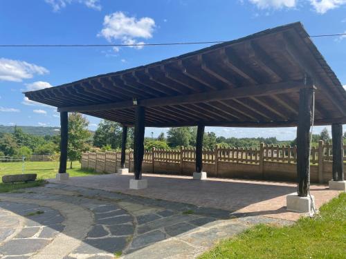 a wooden pavilion with a wooden fence in the background at Pensión Xacobe in Cabreiros
