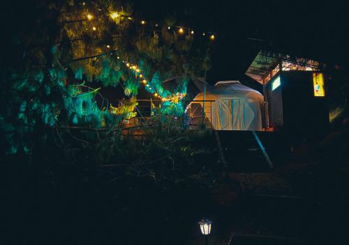 a house with christmas lights on it at night at Refugios de Alta Güita in Suesca
