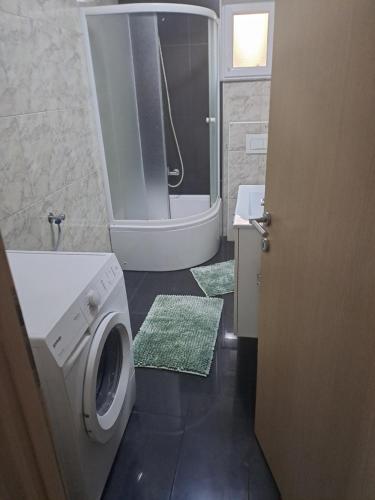 a bathroom with a washing machine and a sink at Apartment Mira in Šibenik