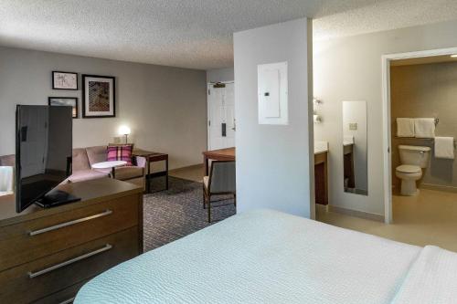 a hotel room with a bed and a living room at Residence Inn by Marriott Anchorage Midtown in Anchorage