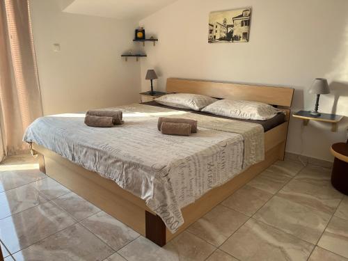 a bedroom with a bed with two towels on it at Apartments Goga in Vodice