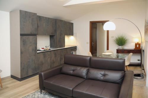 a living room with a couch and a table at Appartamenti Alighieri in Bardolino