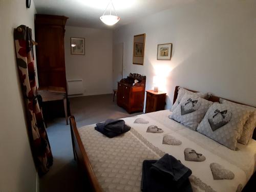 una camera da letto con un letto con asciugamani sopra di Wisteria Cottage a Les Adjots