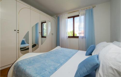 a bedroom with a large bed and a mirror at Gorgeous Home In Labin With Wifi in Mali Turini