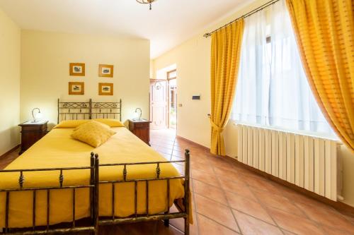 a bedroom with a bed and a large window at Agriresort Tenuta Macchiacupa in Ariano Irpino