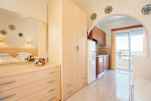 a kitchen with an archway in the middle of a room at Olympus Tilos Apt Twin B1 in Livadia