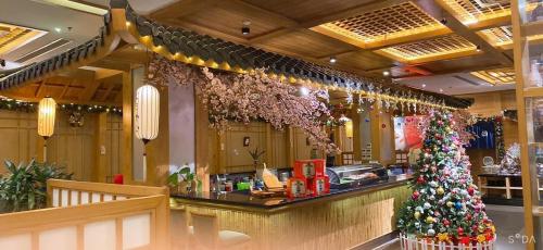 a christmas tree at the counter of a restaurant at Hai Phong Tower - Apartment & Hotel in Hai Phong