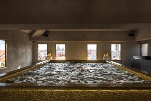 a large pool of water in a room with windows at Nolinski Venezia - Evok Collection in Venice