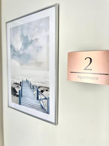 a picture of the ocean with a appointment sign at Lush Porthcawl 1 bedroom Apt, Prime Location in Porthcawl