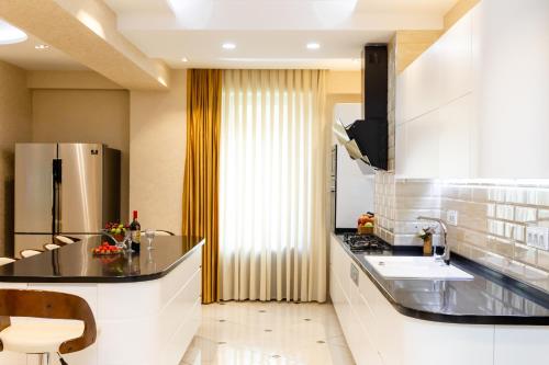 a kitchen with a sink and a counter top at Luxury Apartment in The City Centre lll in Tbilisi City