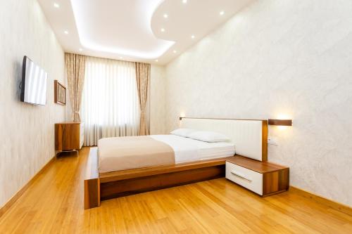 a hotel room with a bed and a window at Luxury Apartment in The City Centre lll in Tbilisi City