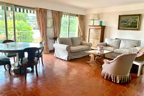 a living room with a couch and a table at Lovely 4-person apartment 200 m from beaches Cap d'Antibes in Juan-les-Pins