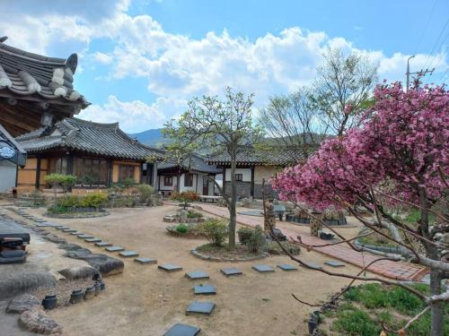 a courtyard with trees and rocks and a building at Yasun Gallery in Gyeongju