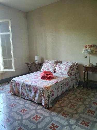 a bedroom with a bed with a red bow on it at Manoir en Crau in Arles