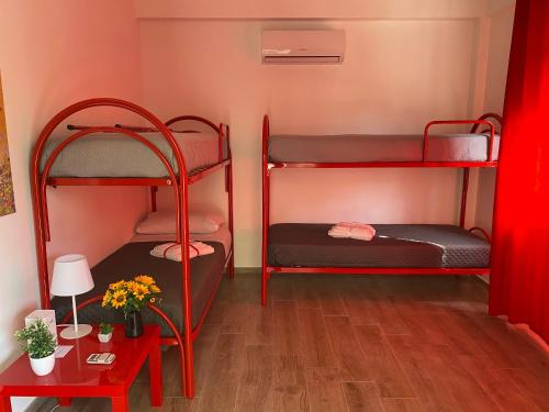 a room with two bunk beds and a table at Casa Narciso - Mondello in Mondello