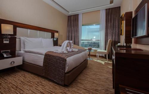 Postel nebo postele na pokoji v ubytování Mitannia Regency Hotel