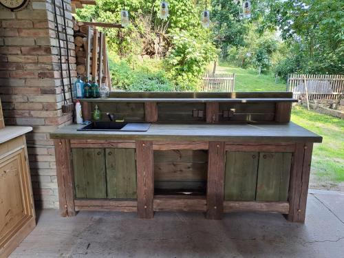 a wooden kitchen island with a sink on a patio at Chalupa Zátyní - celý objekt in Dubá