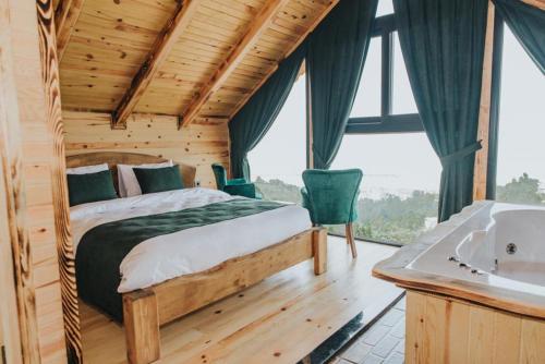 a bedroom with a bed and a sink in a room at Mavera Suit Bungalow in Ardeşen