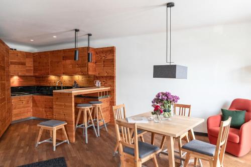 a kitchen and dining room with a table and chairs at Kitzbühel Residences in Kitzbühel