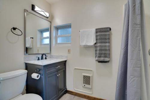 a bathroom with a blue sink and a mirror at Lakefront Washington Home with Private Pool and Sauna in Moses Lake