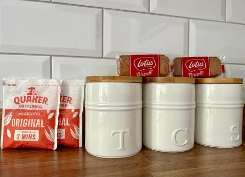 a group of four coffee cans sitting on a table at Apartment 33 Lytham in Lytham St Annes