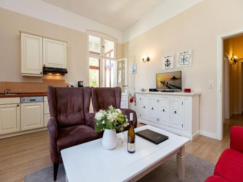ein Wohnzimmer mit 2 Stühlen und einem Couchtisch in der Unterkunft Villa Arcadia, App. 05 in Heringsdorf