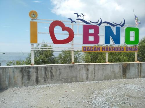 a sign for a brazilian marmalade shop on the beach at As Sufi Villa in Kampung Sungai Air Tawar