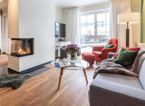 a living room with a couch and a fireplace at Kitzbühel Residences in Kitzbühel