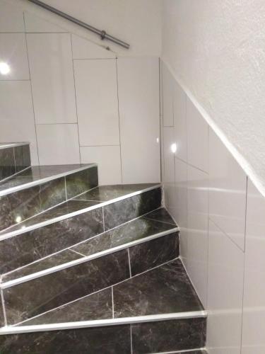 a staircase in a bathroom with marble tiles at Apartment Anđela in Podgora