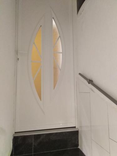 a bathroom with a white door with a window at Apartment Anđela in Podgora