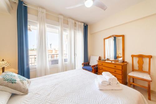 a bedroom with a bed with a mirror and a dresser at Playa Aguadulce, 3 dormitorios in Aguadulce