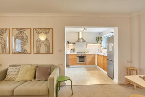 a living room with a couch and a kitchen at Howlyek, in St Agnes Village in St. Agnes